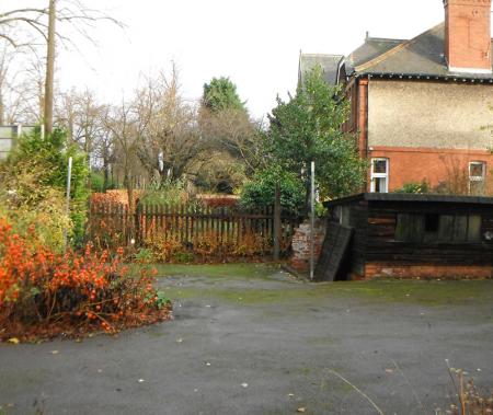 Front garden showing dilapidated brick and timber shed