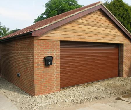 Double garage with oiled cedar wood cladding in Brigg